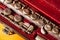 Close-up of vintage brass flute in red velvet case