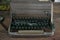 Close up of vintage damaged Typewriter on wooden table.