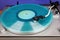 Close up of vintage turntable record player with turquoise vinyl