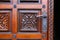 Close-up of vintage wooden hand-carved door with metal handle