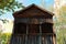 Close-up of vintage wooden windmill. Arched balcony with carved wooden platbands.