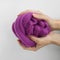 Close-up of violet merino wool ball in hands