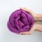 Close-up of violet merino wool ball in hands