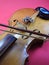 Close-up of a violin, a wooden string instrument, and a bow.