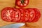 A Close up vivid image of tomato slices on a bamboo cutting board