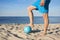 A close-up of volleyball and the mens feet on the beach. The concept of a healthy lifestyle