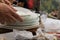 Close up of waiter hands cleaning the table from dirty dishes