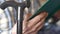 Close-up of a walking stick and the hands of an old man hold the holy scripture bible.An elderly man prays reads a sacred book. Pe