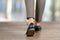 Close-up of walking woman feet in black shoes on the floor