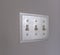 Close up of the wall mounted electrical light switch inside a house