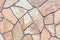 Close-up of a wall tiled with sandstone tiles. Chaotic stone mosaic. Natural stone. A versatile background.