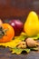 Close up of walnuts lying on tree leaf on wooden desk, autumn ha