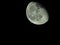 close-up of the waning three-quarter moon in the starry night sky