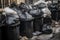 close-up of waste disposal site, with overflowing bins and trash bags