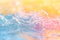 Close up of water with blurry background in delicate pastel yellow pink and blue, hi-res background