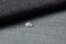 Close up water drop on grey gunny textile. Concept for easy clean, waterproof surfaces