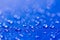 Close up Water drops pattern over a blue waterproof cloth