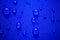 Close up Water drops pattern over a blue waterproof cloth background.