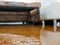 Close up of water flooding on living room parquet floor in a house - damage caused by water leakage