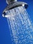 Close-up of water flowing out of chrome shower head