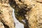 A close up of water inside the rocks at the beach at Crescent Bay beach