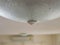 Close up of water leakage dropping through a ceiling lamp at home - problem of water leaking in a house