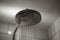 Close-up of water streaming from rain shower head in bathroom. Modern rain shower head