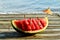 Close up of watermelon on wooden table near the seaside.