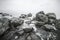 Close-up of waves beating on beach. Rocky sea shore. Top view