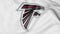 Close-up of waving flag with Atlanta Falcons NFL American football team logo, 3D rendering