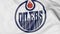 Close-up of waving flag with Edmonton Oilers NHL hockey team logo, 3D rendering