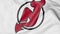 Close-up of waving flag with New Jersey Devils NHL hockey team logo, 3D rendering