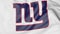 Close-up of waving flag with New York Giants NFL American football team logo, 3D rendering