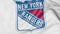 Close-up of waving flag with New York Rangers NHL hockey team logo, 3D rendering
