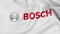 Close up of waving flag with Robert Bosch GmbH logo, 3D rendering