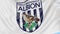 Close-up of waving flag with West Bromwich Albion FC football club logo, seamless loop, blue background. Editorial