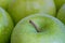 A close up of waxed green apples