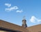 Close up of a weather vane on a roof,wind indicator, over blue sky