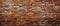 Close up of a weathered brown brick wall made of composite building material