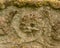 Close up of weathered skull carved into 18th century grave stone