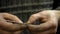 Close-up of weaving a silver bracelet, the hands of a master jeweler make a new product, selective focus