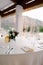 Close-up of a wedding dinner table - forks lie on a napkin. Table in background of the garland, on the table are glasses