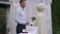 Close-up of Wedding on paper with rings in box on table and blurred affectionate loving couple at altar background