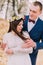 Close up wedding portrait of cheerful stylish newlywed bride and groom hugging outdoor