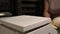 Close-up of weighing dough before baking bread. Craft bakery. Fast Professional Work of Bakers