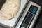 Close-up of weighing dough before baking bread. Craft bakery. Fast Professional Work of Bakers