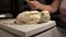 Close-up of weighing dough before baking bread. Craft bakery. Fast Professional Work of Bakers