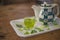 Close up Welcome Green tea with tea pot on the wooden table