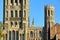 Close-up on the Western part of the Cathedral of Ely in Cambridgeshire, with the clock tower on the left and a turret