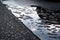 close-up of wet asphalt, with raindrops and reflections